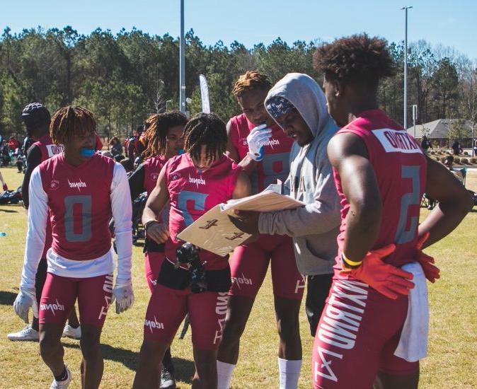 CJ Cannon discusses a play during a timeout with his players